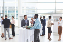 Business people discussing over documents at table during a seminar