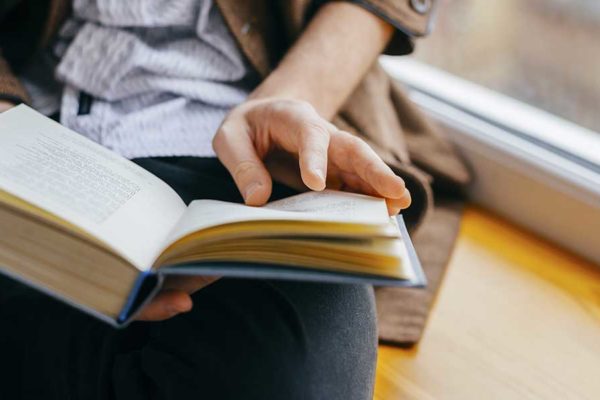 close-up of person holding book