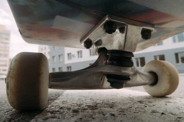 underside of skateboard on pavement